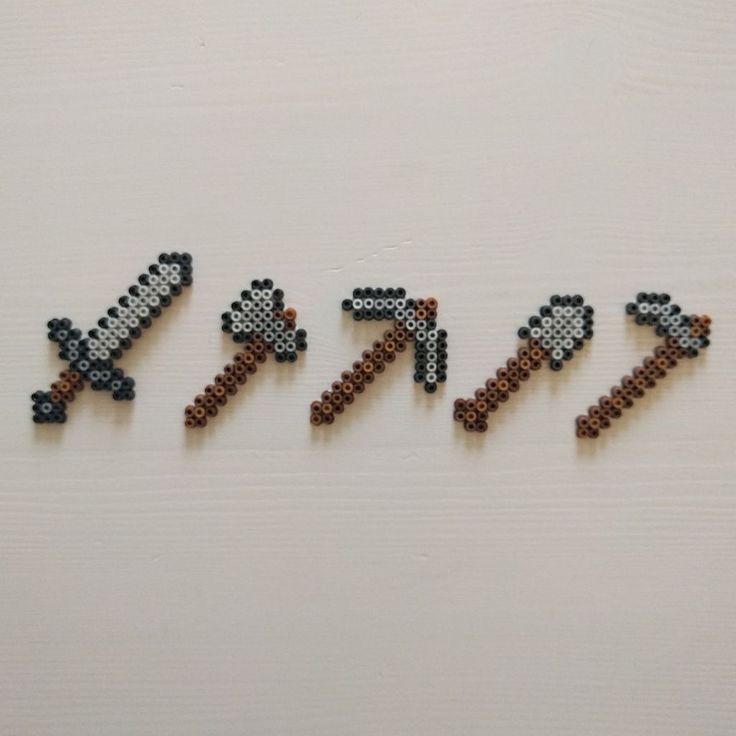 the letters are made out of beads and have different designs on them, including an arrow