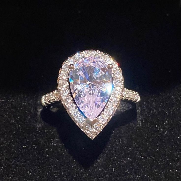 This Stunning Water Drop Simulated Diamond Ring Set In A Tension Mount Has A 3.47ct Center Stone With .5ct Halo White Gold Plated Silver Ring & Stamped S925. This Stones Show Quality Is Almost Indescribable, The Photos Can’t Even Pick Up All The Rainbow & Kaleidoscope Colors It Shows. The Photos Posted Show White, Purple, Pink & Silver But Are Missing The Beautiful Blues. Even The Mount Is Gorgeous! Size 6,7,8,9 White Gold Teardrop Jewelry For Proposal, Elegant Pear-shaped Jewelry With Vs Clarity, Silver Pear-shaped Jewelry For Proposal, Pear-shaped Jewelry With Diamond Accents For Proposal, Halo Ring With Prong Setting For Proposal, Halo Ring Fine Jewelry, Dazzling Heart Cut Ring, Teardrop Diamond Accent Jewelry For Proposal, Elegant Silver Teardrop Crystal Ring