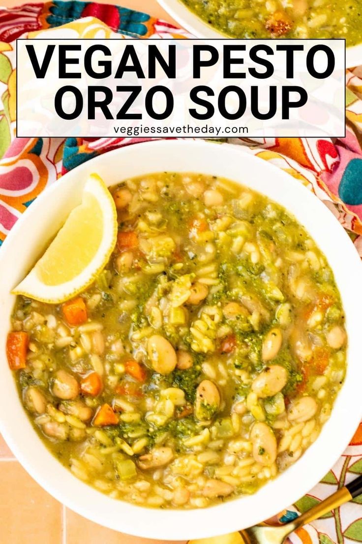 vegan pesto orzo soup in a white bowl with a lemon wedge on the side