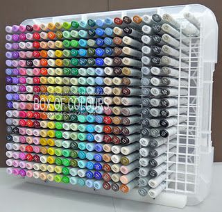 a large plastic container filled with lots of different colored crayons on top of a table