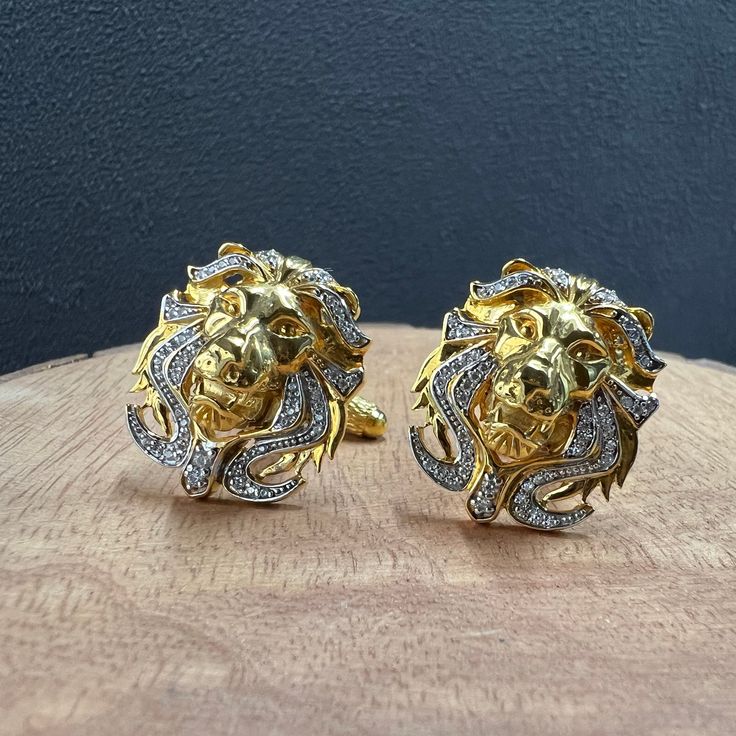 Introducing our exquisite Royal Lion Head Cufflink Set, a testament to both regal elegance and unique craftsmanship. Handcrafted with precision and care, each cufflink and lapel pin showcases a meticulously designed lion head in a luxurious 14k gold finish with  Cubic zircomnia diamonds set in the lion's mane. The intricate detailing captures the essence of this majestic creature, symbolizing courage and leadership. It is the perfect eye catching statement piece  displayed on your cuff. sAperfect for animal enthusiasts and spiritual individuals. A gift for the perfect LEO. Casted in brass with 14k gold Plating Each cufflink is handmade by skilled artisans in India Cufflink comes in a sturdy Cufflink storage box *Suitable for Every Celebration* Be it a holiday like Christmas, a birthday bas Regal Elegance, Majestic Lion, Lion's Mane, Lion Mane, Gifts Anniversary, Gold Cufflinks, Perfect Eyes, Cufflink Set, Lion Head