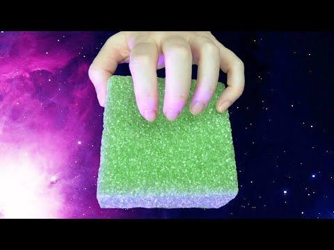 a hand holding a sponge in front of a purple and blue space with stars on it