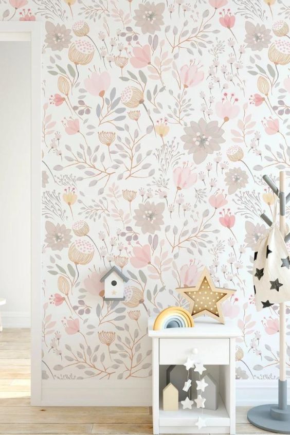 the wallpaper in this room is painted with pastel colors and has flowers on it