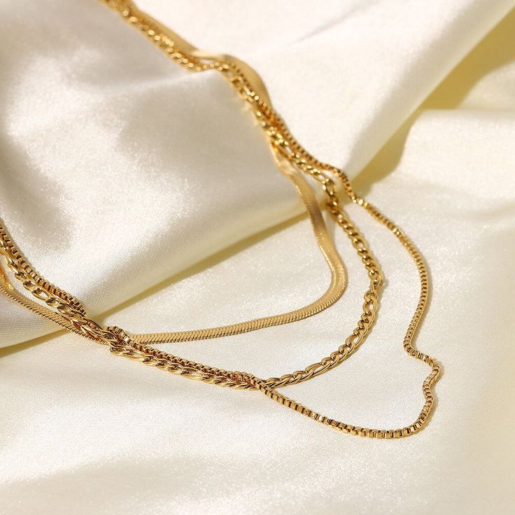 This Layered Chain Necklace combines multiple 18k gold-plated strands for a chic, multi-layered look. It’s an effortlessly stylish piece, adding depth and texture to any outfit, suitable for both casual and formal occasions. Gold-tone Multi-strand Necklaces For Layering, Dainty Layered Snake Chain Necklace, Chic Gold-tone Delicate Chain Necklace, Chic Gold-tone Multi-strand Jewelry, Elegant Gold-tone Chain Necklace For Layering, Chic Multi-strand Gold-tone Jewelry, Trendy Gold Plated Delicate Chain Layered Necklace, Chic Gold Multi-strand Jewelry, Chic Gold-plated Layered Chain Necklace