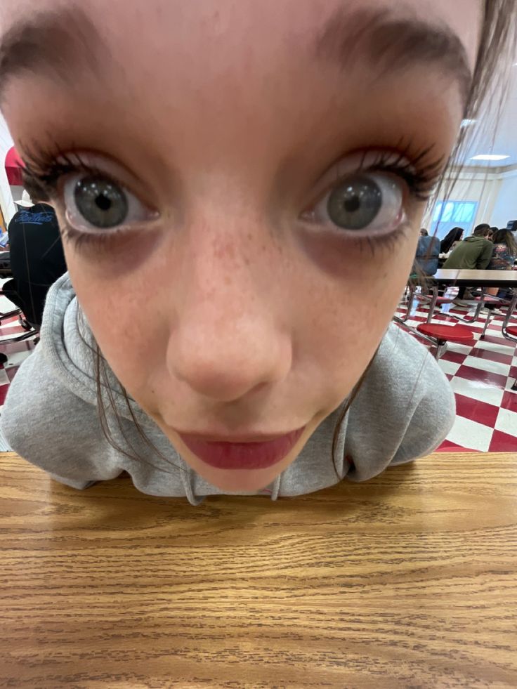 a close up of a child's face on a table