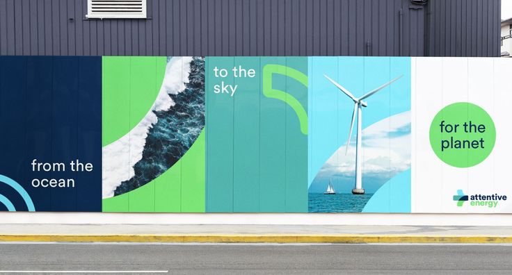 a large mural on the side of a building with windmills and ocean scenes painted on it