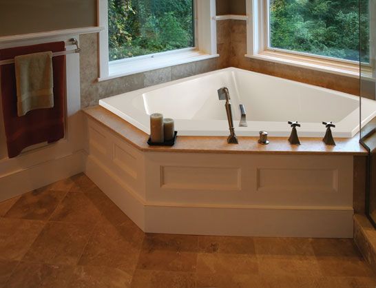 a bathroom with a large jacuzzi tub and two windows