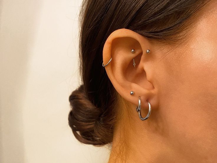 a close up of a person with ear piercings