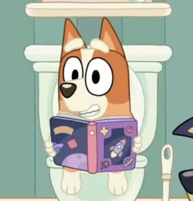 a cartoon dog sitting on top of a toilet holding a book in it's paws