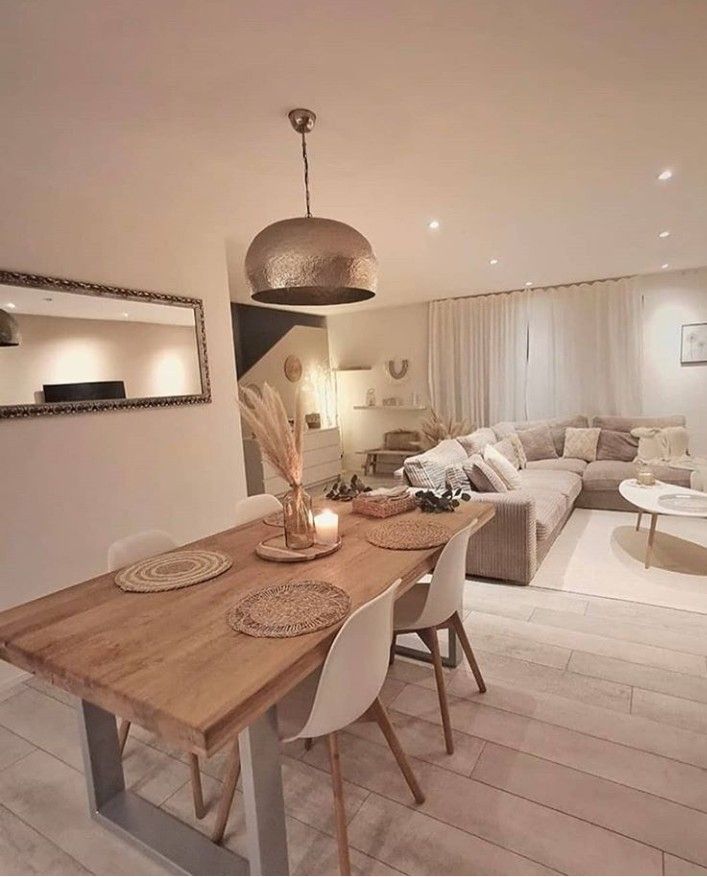 a living room and dining area with white furniture