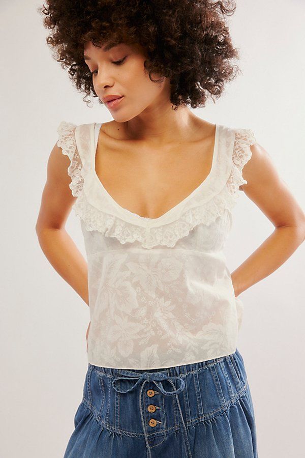 Absolutely ethereal, this semi-sheer cami is featured in a floaty, cropped silhouette with fluttering lace trim and a sweet floral pattern. **Fit:** Breezy, cropped **Features:** Semi-sheer cotton fabrication, voop neckline, lace trim and flutter sleeves, empire waist, adjustable tie straps, floral pattern **Why We | Making Me Blush Cami by Intimately at Free People in White, Size: S Fancy Casual, Quoi Porter, Senior Picture Outfits, Stunning Tops, Sweet Floral, Preppy Outfits, Flutter Sleeves, Dream Clothes, Lace Tops