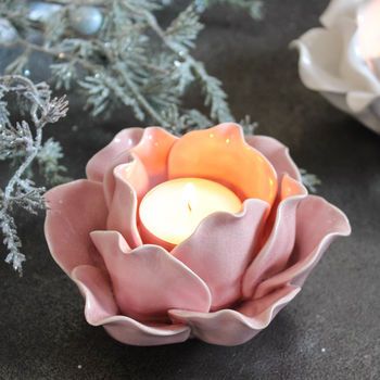 a pink flower with a lit candle in it