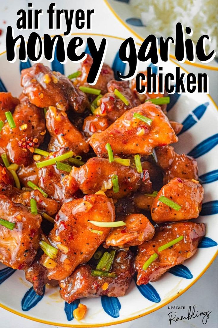 an air fryer honey garlic chicken in a white and blue bowl with the title above it