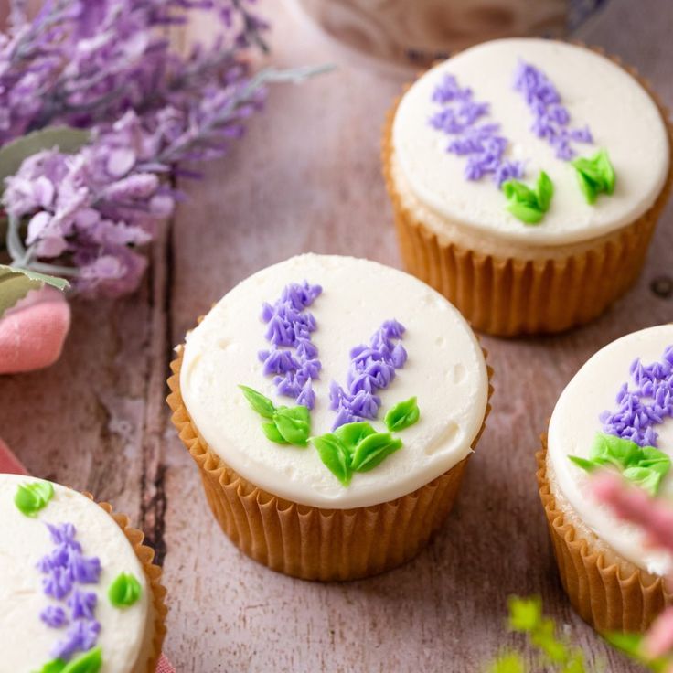 cupcakes decorated with purple flowers and green leaves