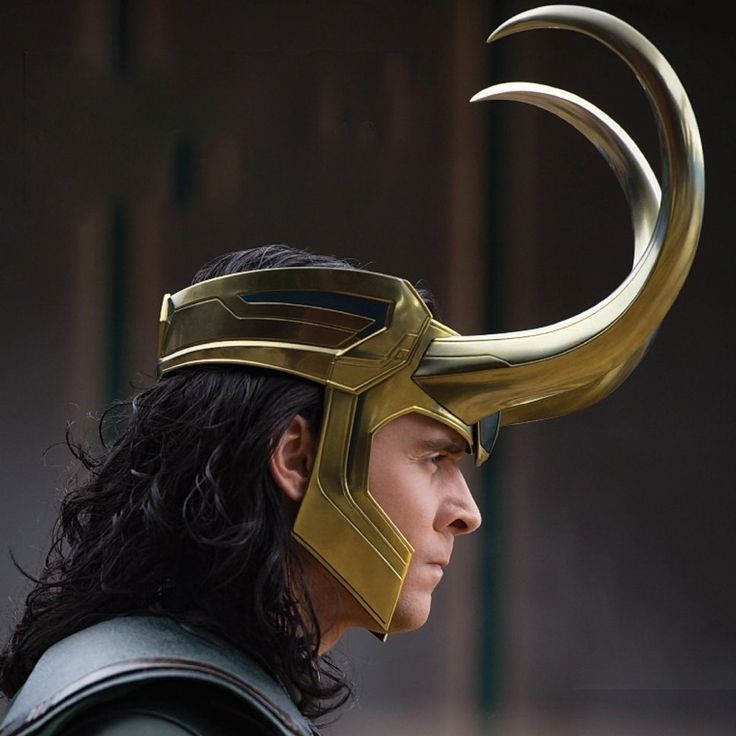 a close up of a person wearing a helmet with horns