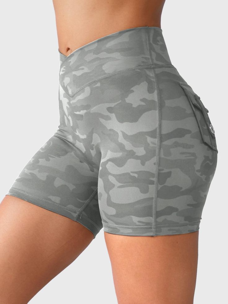 Elevate your workout with our Charm Camouflage Shorts, designed with a seamless front for comfort and stylish ruching to enhance your curves. Featuring practical utility pockets and a trendy camo print, these durable shorts blend fashion with performance for ultimate versatility.    Feature    V-waistband design   Trendy Camo Print   Dual Back Pockets   Scrunch on the buttocks   No front seam, no camel toe   High elasticity, Moisture wicking      Fabric    74% Nylon + 26% Spandex     Model Measurements    Model Wear: S   Height: 173cm / 5'7"   Bust: 87cm / 34.3″   Waist: 62cm / 24.4″   Hips: 97cm / 38.2″ Camouflage Shorts, Compression Tights, Workout Attire, Waist Workout, Workout Running, Spandex Shorts, Shorts For Women, Active Shorts, Squat Proof