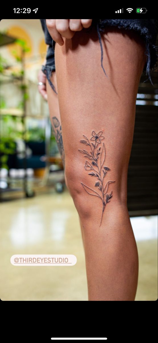 a woman's legs with tattoos on them and the bottom part of her leg