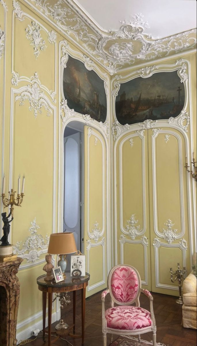 an ornately decorated room with a pink chair