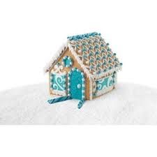 a gingerbread house is decorated with blue and white decorations