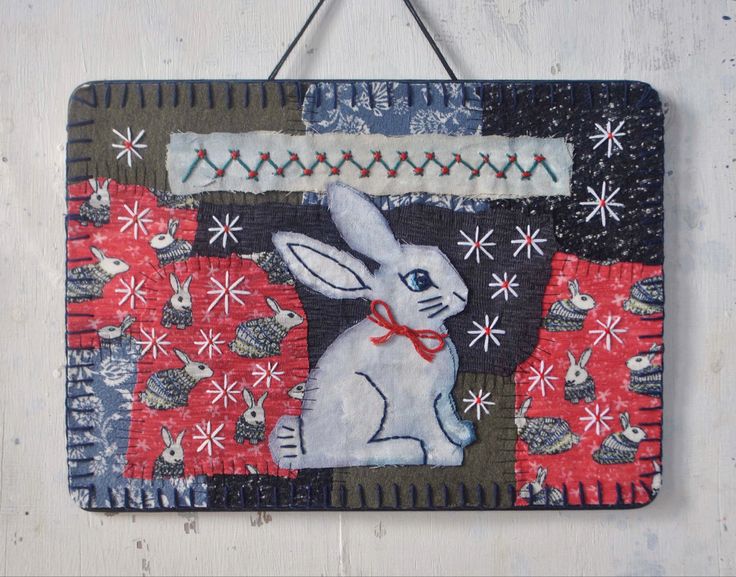 a wall hanging with an image of a rabbit on it