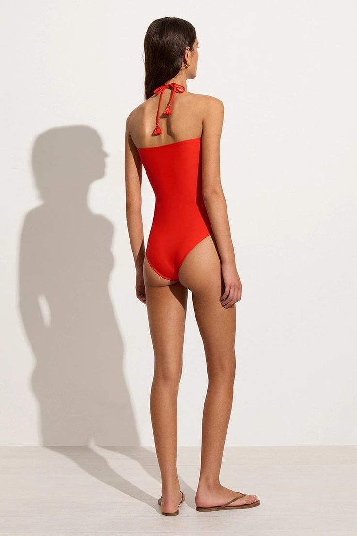 The Ola One Piece is a halter swimsuit with a gathered bodice, moderate coverage and front keyhole cut out with drawstring ties designed to tie around the neck. Crafted from regenerated nylon in a statement Salsa Red, the Ola is a timeless piece that easily transitions to a summer bodysuit with linen pants. Nylon Swimwear With Drawstring For Swimming, Beachwear Tied Swimwear For Swimming, Halter Neck Polyamide Swimwear For Vacation, Red Drawstring Swimwear For Swimming, Nylon Drawstring Swimwear For Poolside, Drawstring Nylon Swimwear For Poolside, Nylon Halter Neck Swimwear For Vacation, Tied Halter Neck Swimwear For Vacation, Halter Neck Swimwear With Tie Back For Beach Season