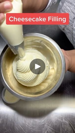 a person pouring cheesecake filling into a mixing bowl with the words cheesecake filling on it