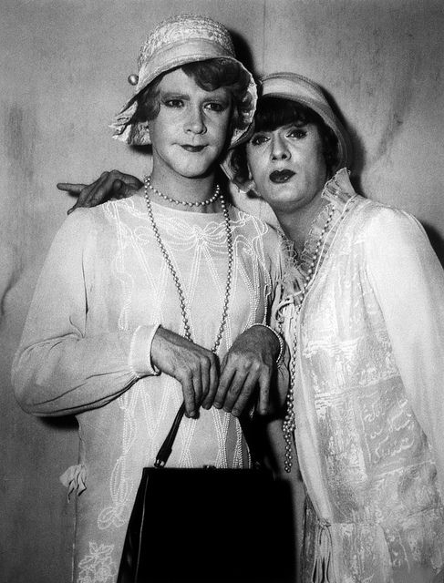 black and white photograph of two women dressed in old fashion clothing posing for the camera