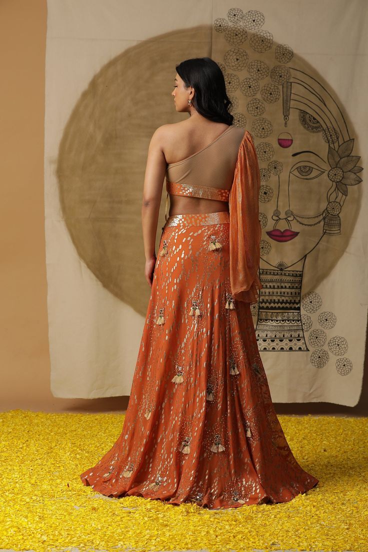 feauring Rust Orange skirt set in gorgette. Comes with sequined blouse and ruffled dupatta Fabric : GEORGETTE ORANGE Color FIT FITTED Lining Material crepe 1 month Delivery 3 Components Orange Lehenga With Gota Work In Traditional Drape, Orange Pre-draped Party Saree With Zari Work, Traditional Orange Pre-draped Party Saree, Party Orange Pre-draped Saree With Zari Work, Orange Zari Work Pre-draped Saree For Party, Orange Pre-draped Saree With Dupatta For Party, Fitted Orange Pre-draped Saree For Wedding, Orange Bollywood Blouse Piece For Party, Orange Georgette Pre-draped Saree With Dupatta