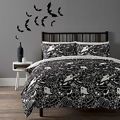 a black and white bed in a bedroom with bats on the wall next to it