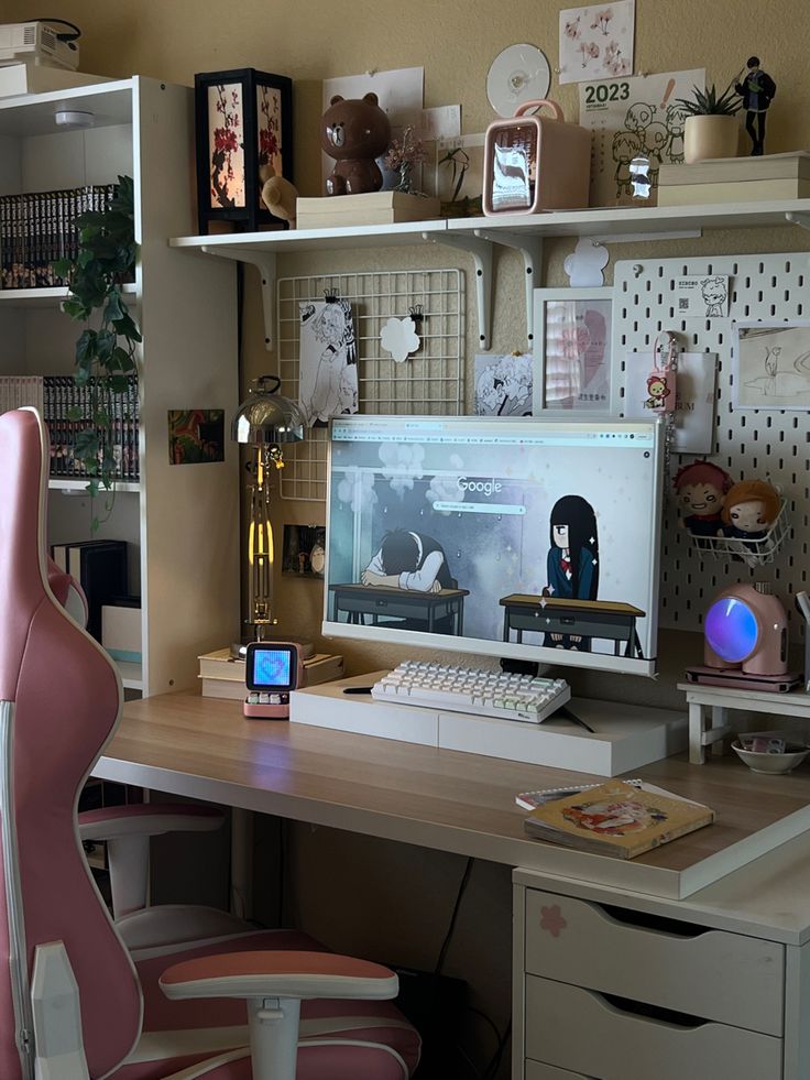 a desk with a computer monitor, keyboard and mouse on it next to a pink chair