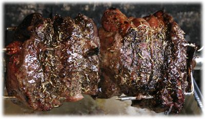 two steaks are being cooked on the grill