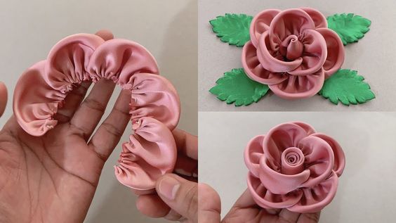 there is a pink flower with green leaves in the shape of a rose on it