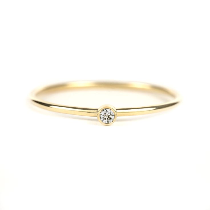 Dainty 1.75mm Diamond Ring -Recycled yellow gold (choose 10K or 14K) -1.75mm salt and pepper diamond diamond (gray diamond) -1mm band (round silhouette) -Bezel is set on top of band for stacking -Polished finish (satin finish available upon request) -Full, half and quarter sizes 2-10 (contact me for other sizes) -Free US shipping PRODUCTION TIME: Rings take approximately 5-7 business days to make. PACKAGING: All purchases are shipped in a jewelry box stamped with my logo--perfect for giving as a Yellow Gold Stacking Rings, Olive Jewelry, Tiny Diamond Ring, Gold Stacking Ring, Gray Diamond, Tiny Rings, Pepper Diamond, Bezel Ring, Gold Ring Stack