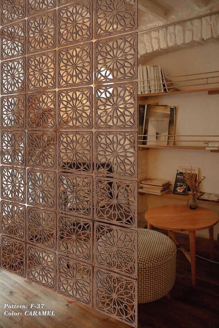 the room divider is made out of wood and has an intricate design on it