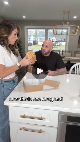 a man and woman standing in front of a kitchen counter with food on top of it