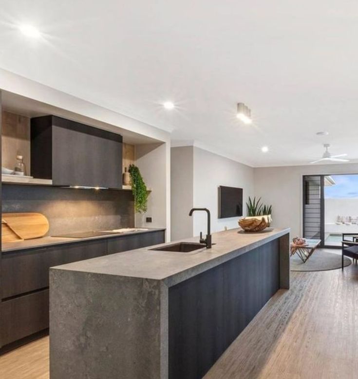 an open concept kitchen and dining room with large sliding glass doors leading to the balcony