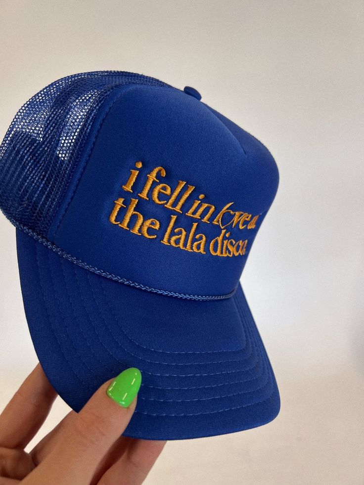 Lala Original Design thoughtfully designed in-house. These clothes were made for you.- Trucker style hat- Foam front + mesh back- Gold embroidered lettering- Royal blue hat base- Adjustable snap back-- one size fits all100% polyester**All accessories are final sale. No exceptions. © Dressed in LALA™ 2024 // Design owned and created by Dressed in LALA™ Satin Playsuit, Dressed In Lala, Embroidered Lettering, Hat Base, 2024 Design, Blazer Set, Flannel Jacket, Sweater Collection, Blue Hat