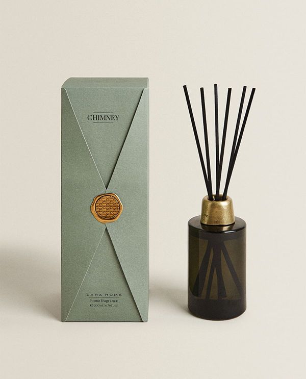 a green box next to a black and gold reed diffuser