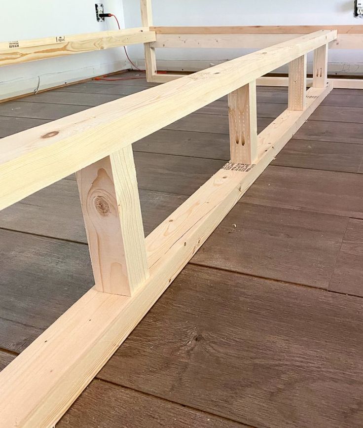 a wooden bench sitting on top of a hard wood floor