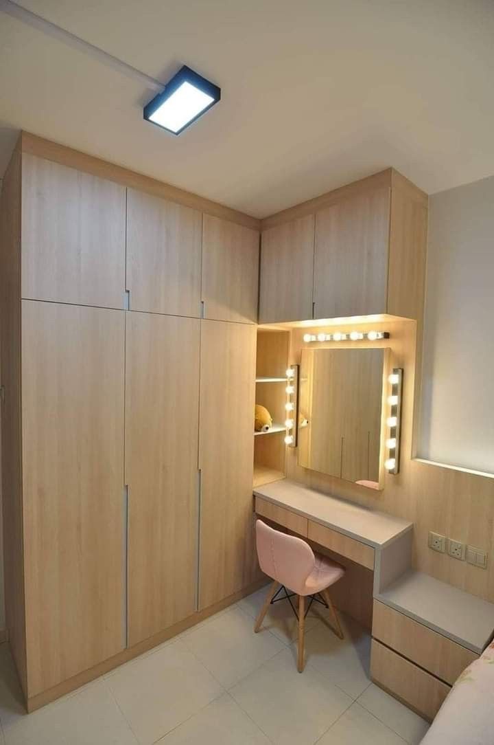 a bedroom with a vanity, mirror and dressing table