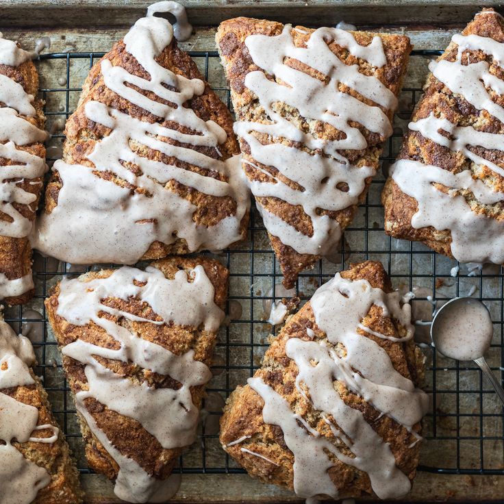 freshly baked pastries with icing on a cooling rack