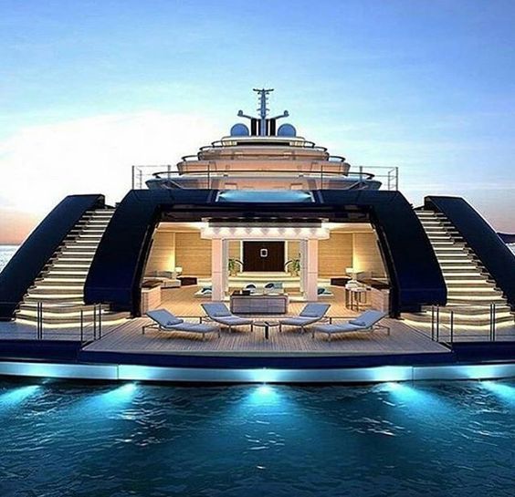 a large boat that is floating in the water with stairs leading up to it's upper deck