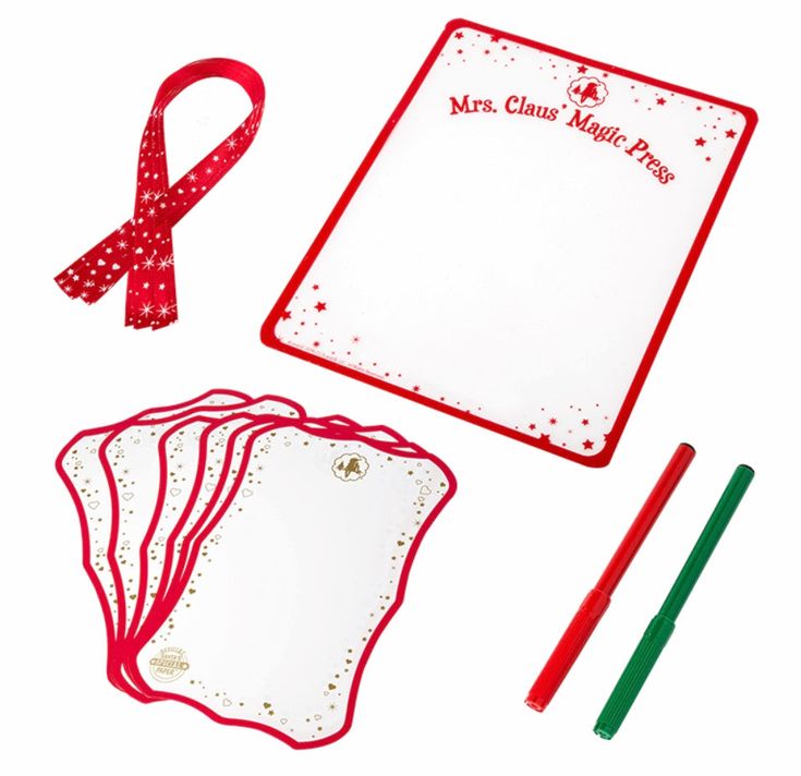 a red and white christmas writing set with paper, markers, pencils and marker