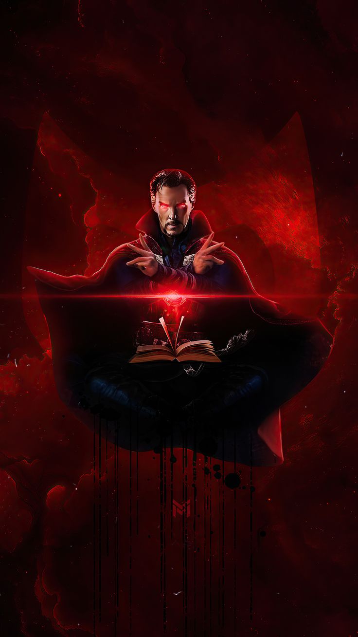 a man sitting on top of a book under a red light