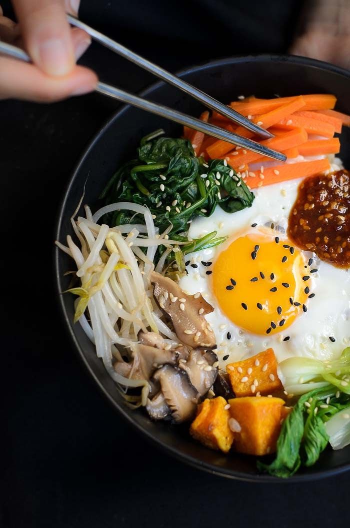 a bowl filled with different types of vegetables and eggs on top of eachother