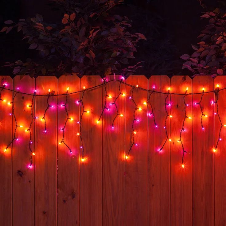 a wooden fence with christmas lights hanging from it's sides and the words diy christmas outdoor decoration