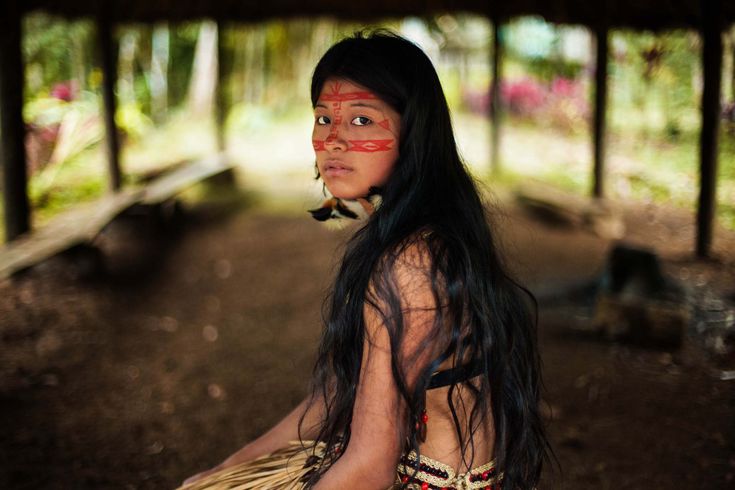 a native american woman sitting on the ground