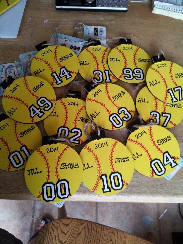 a table topped with lots of yellow baseballs covered in numbers