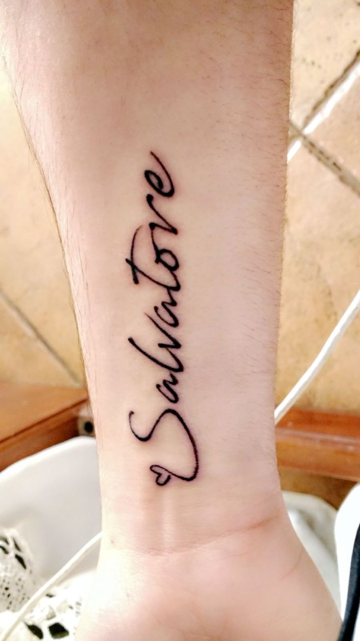 a person with a tattoo on their wrist that says, love is patiently written in cursive writing