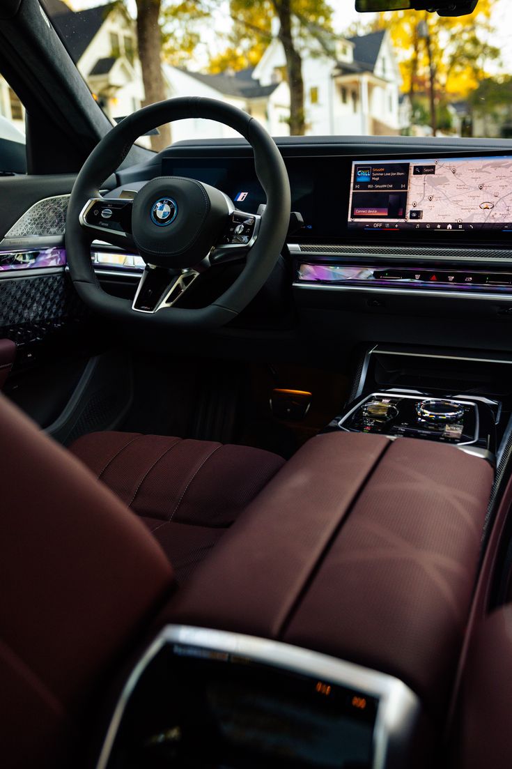 the interior of a modern car with red leather seats and electronic display on the dashboard